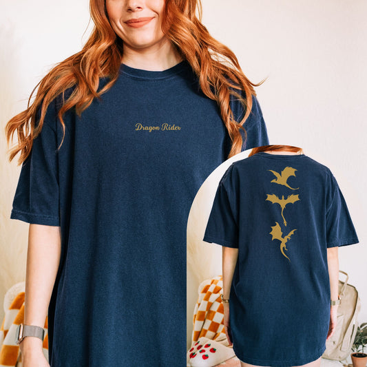 The dragon rider t-shirt has a 
design of three golden dragons on the back and in the front the text dragon rider in a Calligraphy font. The text is embroidered. 
The model is wearing true navy.