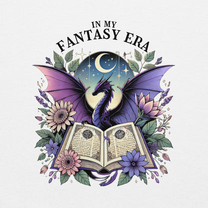 The in my fantasy era sweatshirt has a design of a purple dragon behind an open fantasy book and they are surrounded by purple and pink flowers. The text above the dragon says: in my fantasy era.
This is a close up of the design